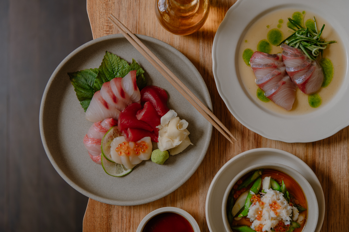 Sashimi—arranged on plates—on a wooden table