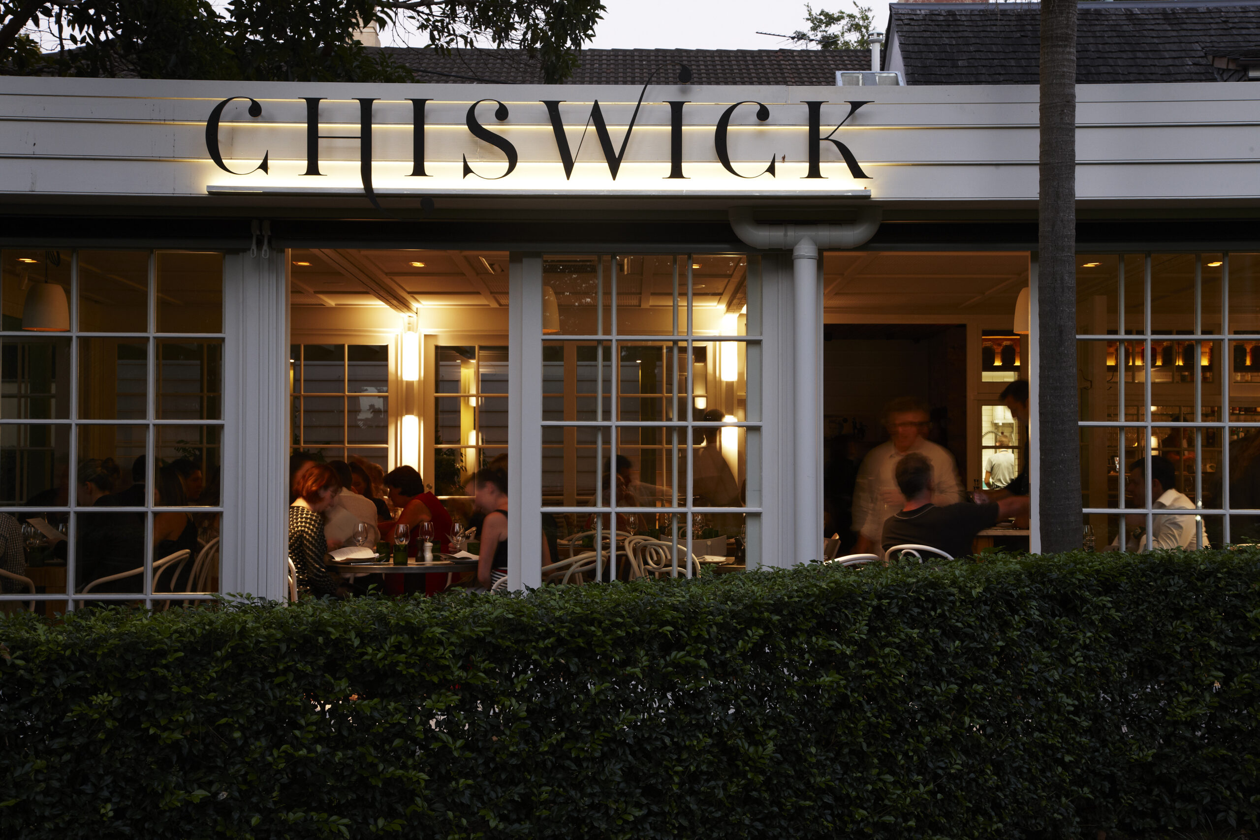 A restaurant, Chiswick, is shown at night