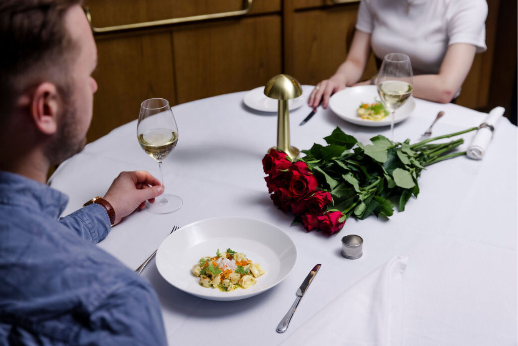 A man sits at a table, enjoying a meal
