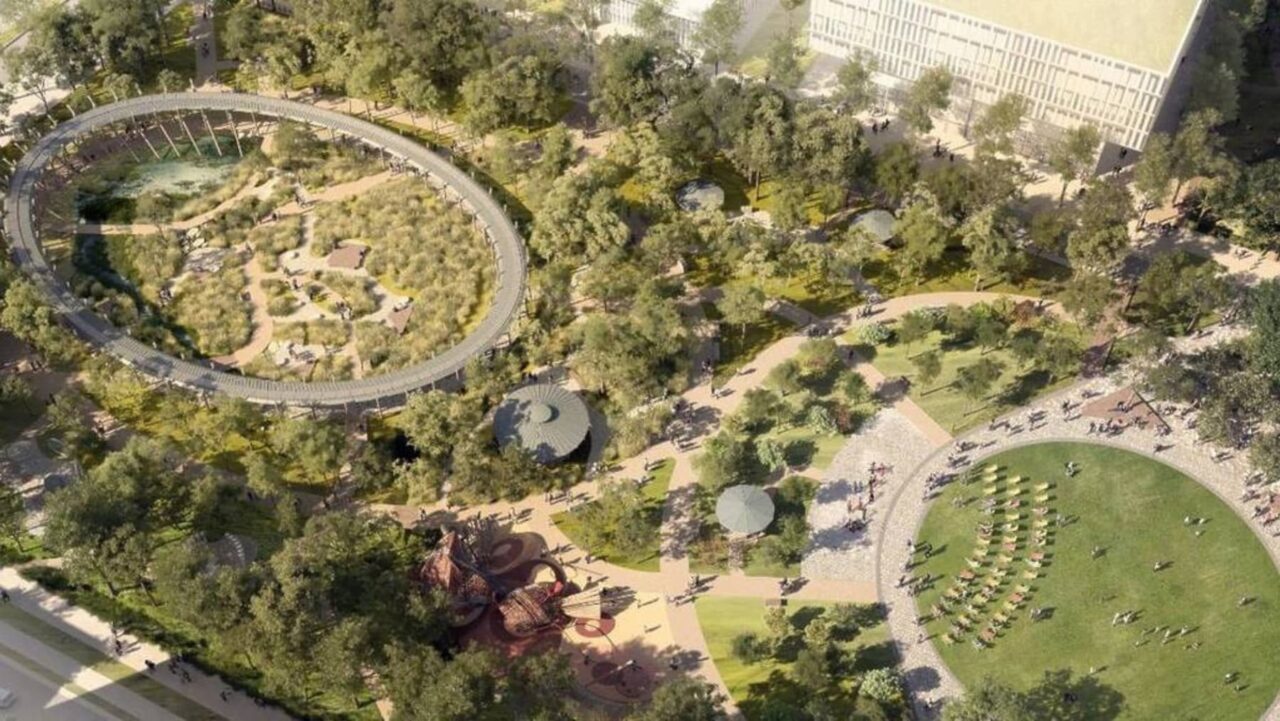 An elevated, oval walkway encircles a central parkland, featuring various plant life, pathways, and seating areas