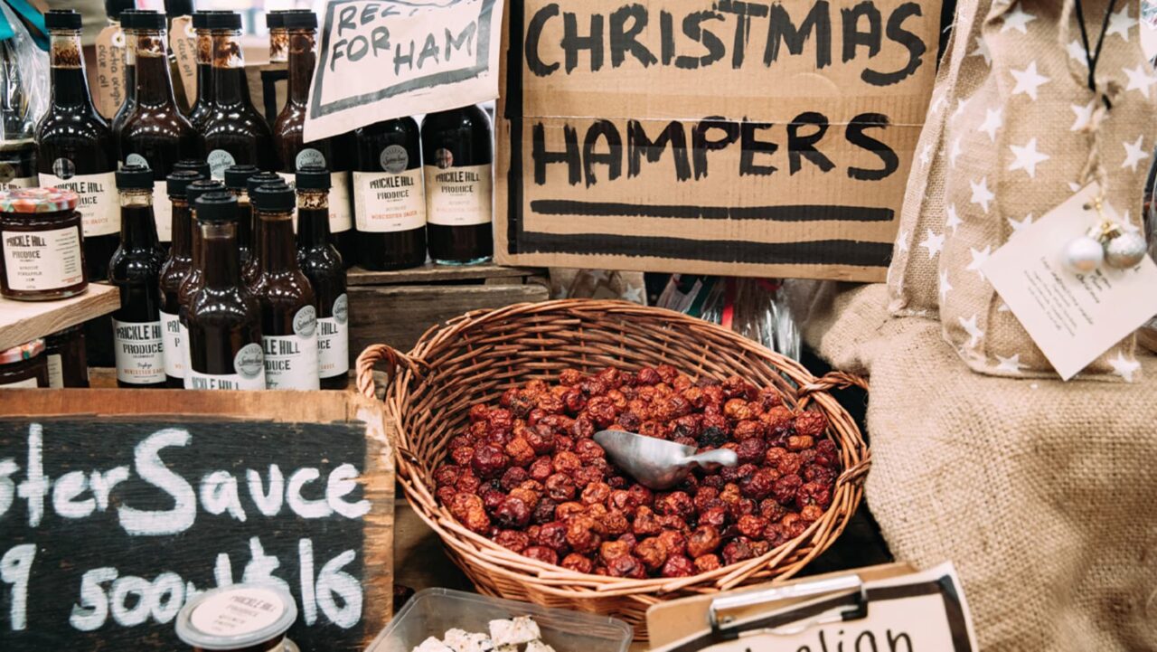 A wicker basket contains dried, red berries; a small scoop rests inside