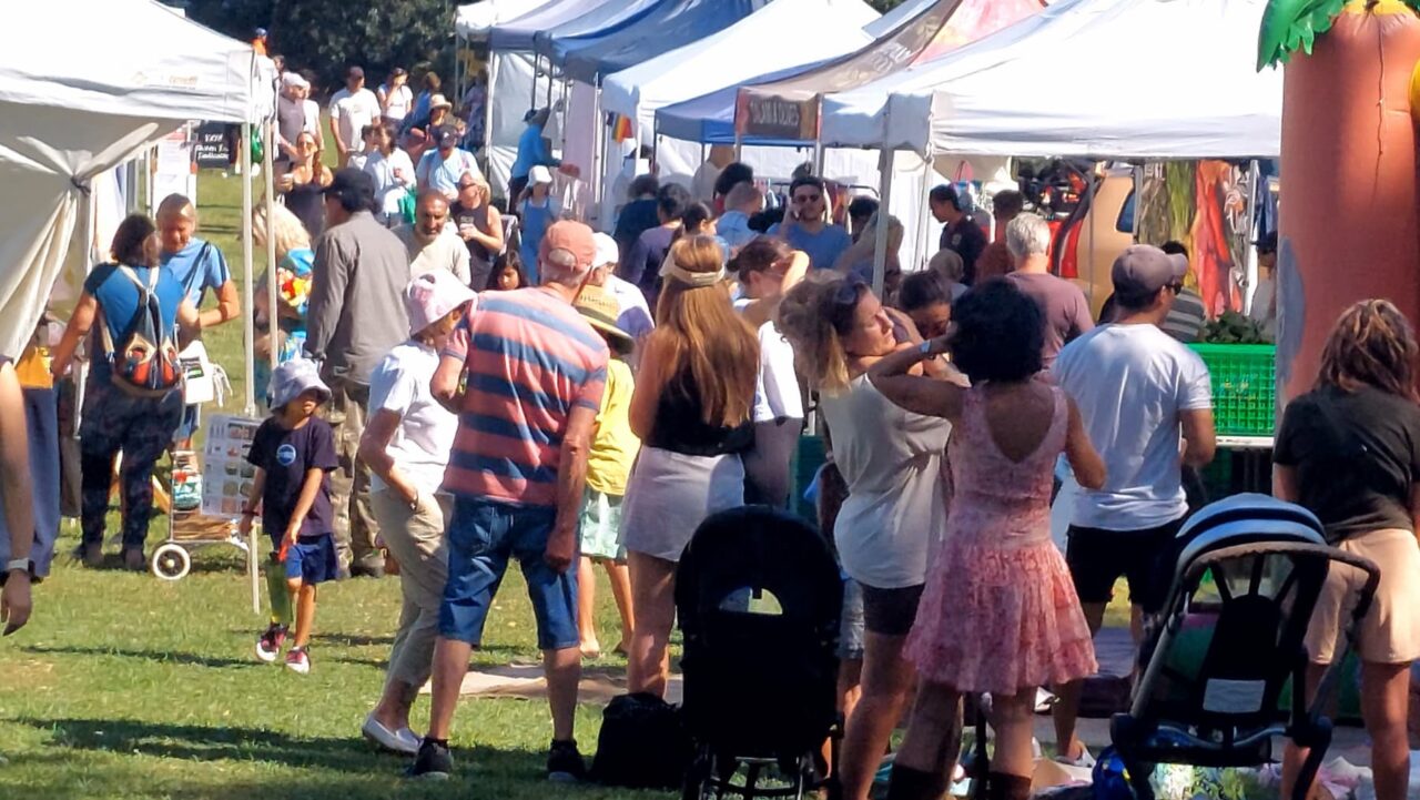 People browse stalls at an outdoor market