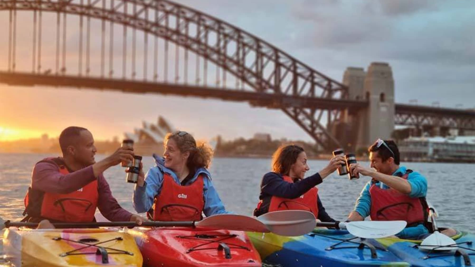 Kayakers toasting at sunset sydney