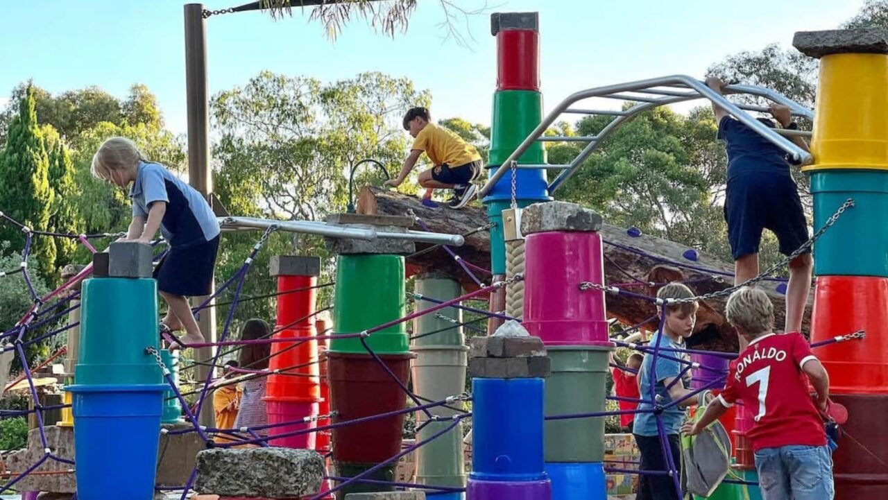 a group of kids playing at a playground