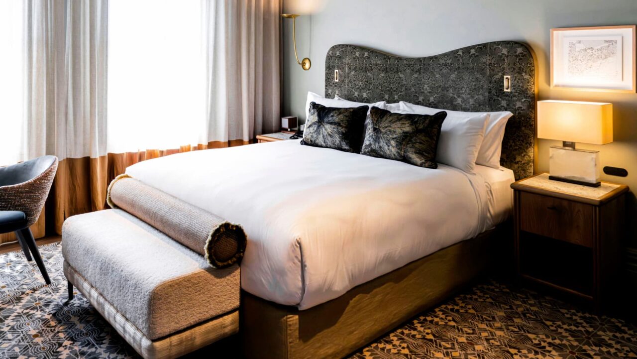 A bed at The Grand National Hotel by Saint Peter in Sydney, Australia