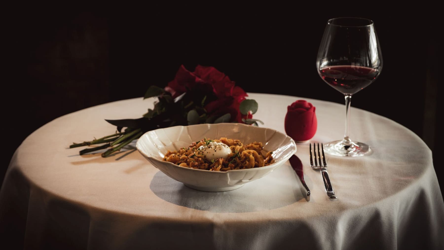 A plate of pasta and wine on a table