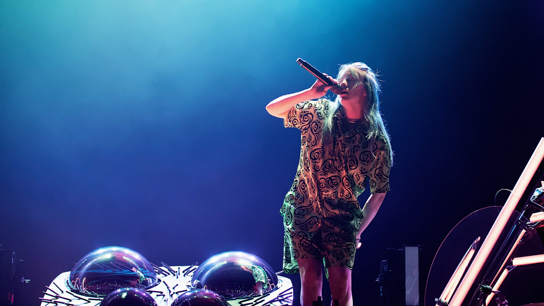 Fans prepare to see Billie Eilish in Sydney. She is pictured on stage against a blue background