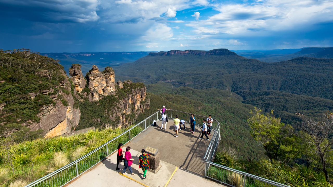 Tourists look out over the Three Sisters in the Blue Mountains.
