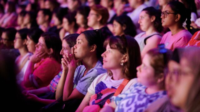 Women listen intently at a talk for International Women's Day