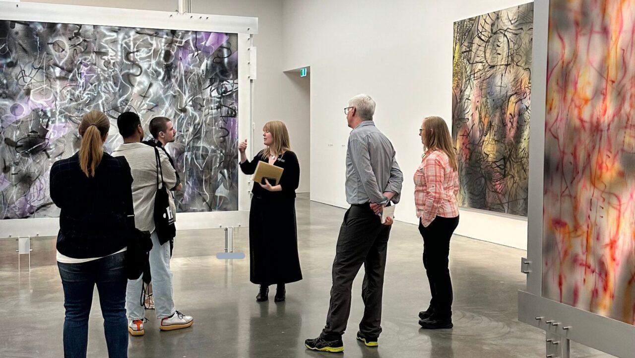 A tour guide explains more about Julie Mehretu's TRANSpaintings series at the solo exhibition at Sydney's Museum of Contemporary Art.