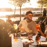 Two people having a drink during sunset.