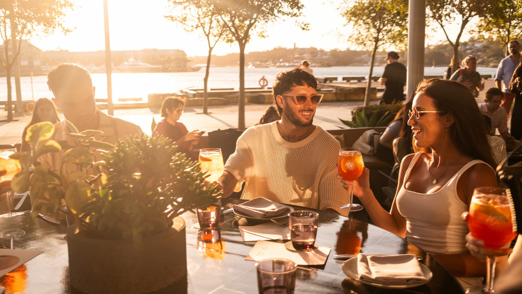 Two people having a drink during sunset.