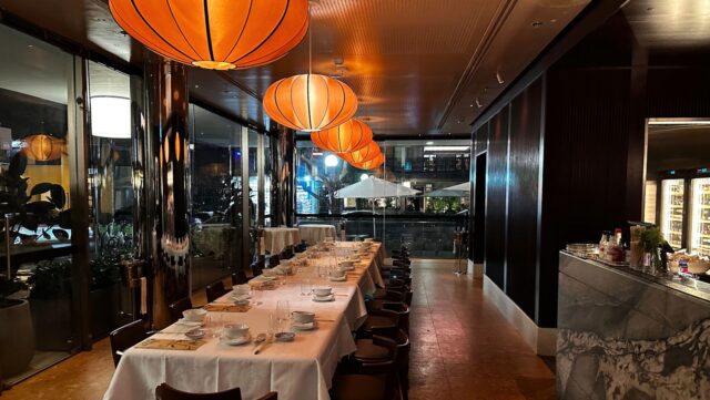 a long table with white plates and glasses