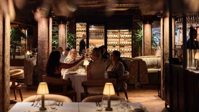 a group of people sitting at tables in a restaurant