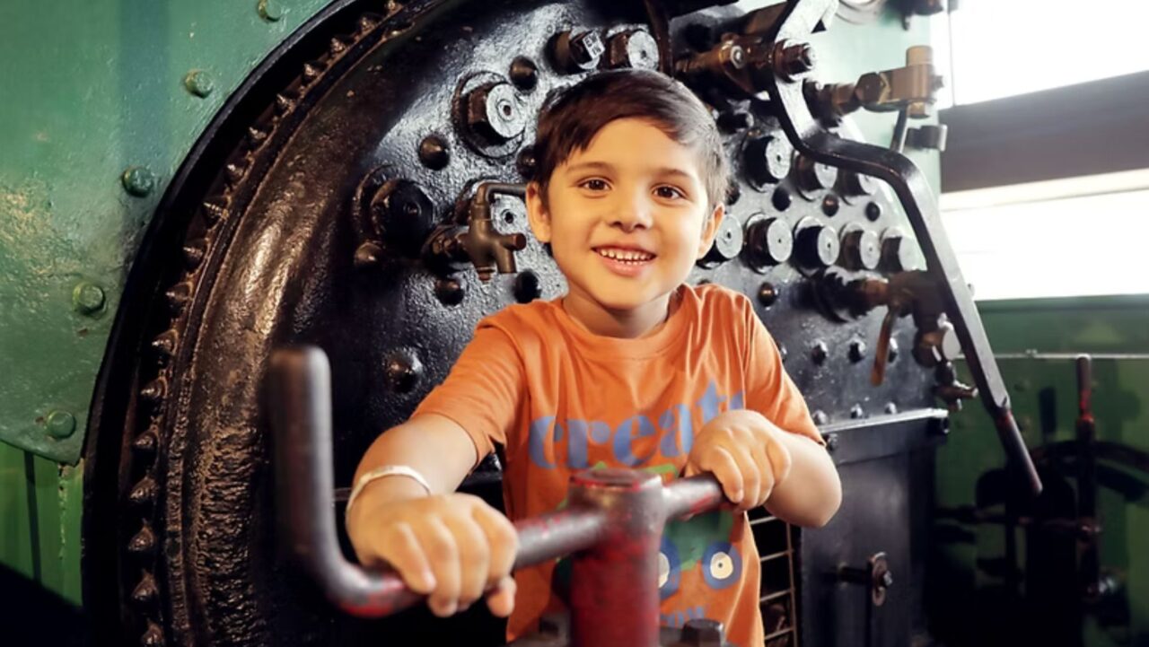 a kid has fun at the rail museum