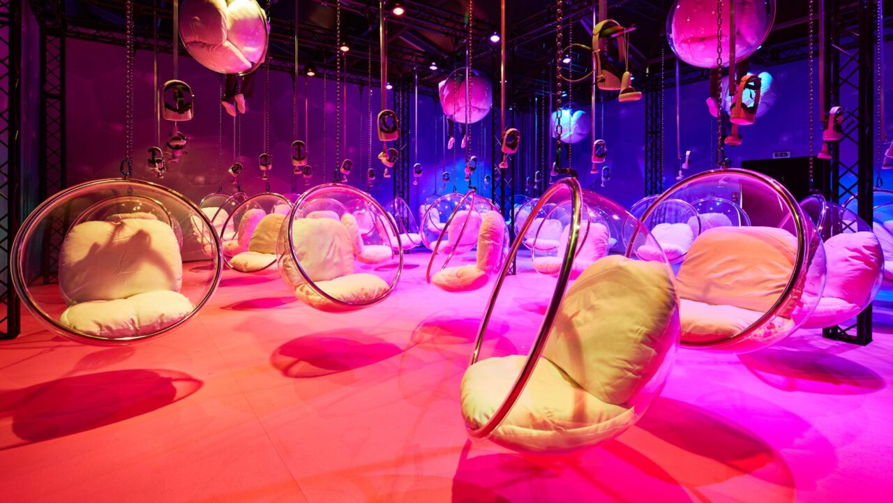 a room with chairs and purple lights