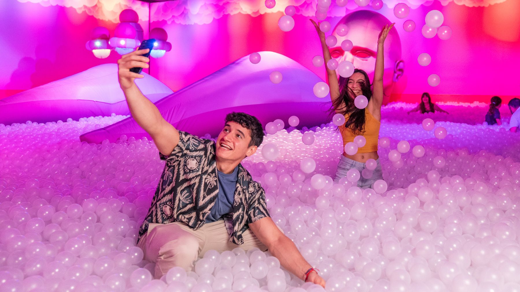 a man and woman in a ball pit