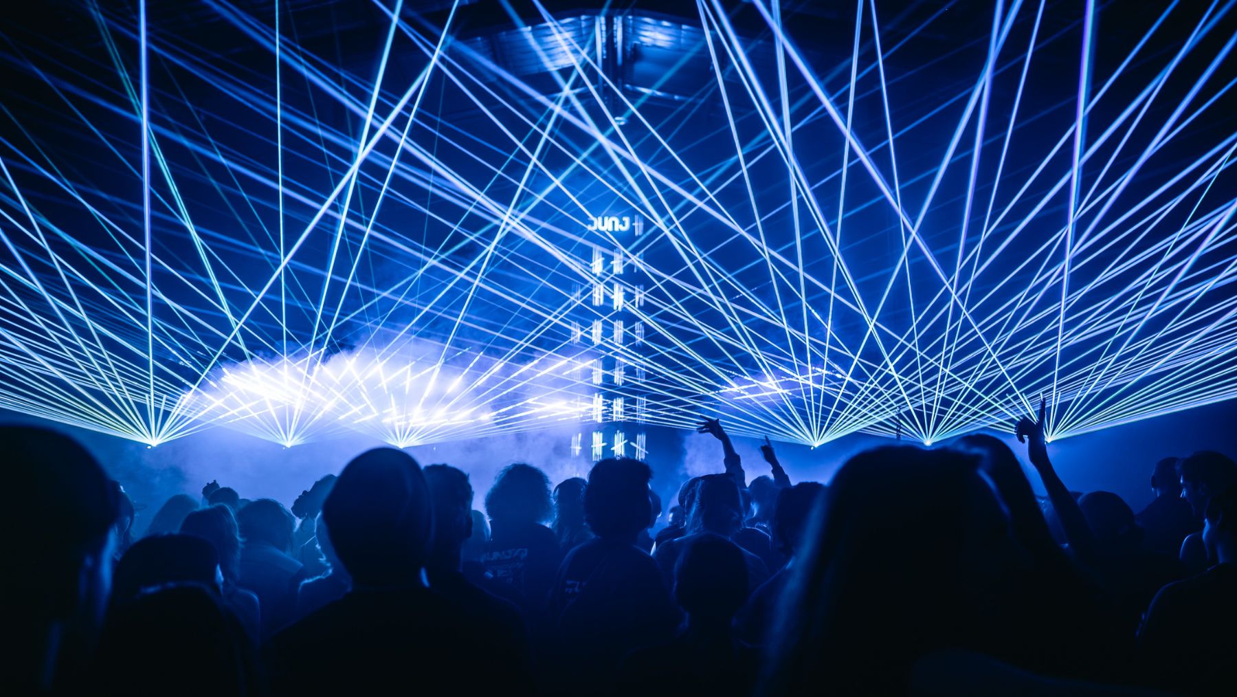 Revellers are pictured beneath lasers and lights that say DUNJ. The Sydney-based crew will host a late-night party in The Studio at Sydney Opera House this weekend.