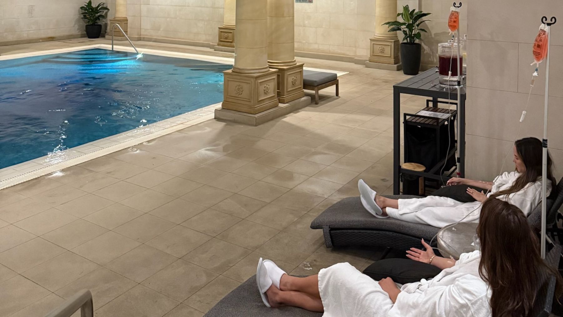 woman at the pool of the langham getting IV drip therapy