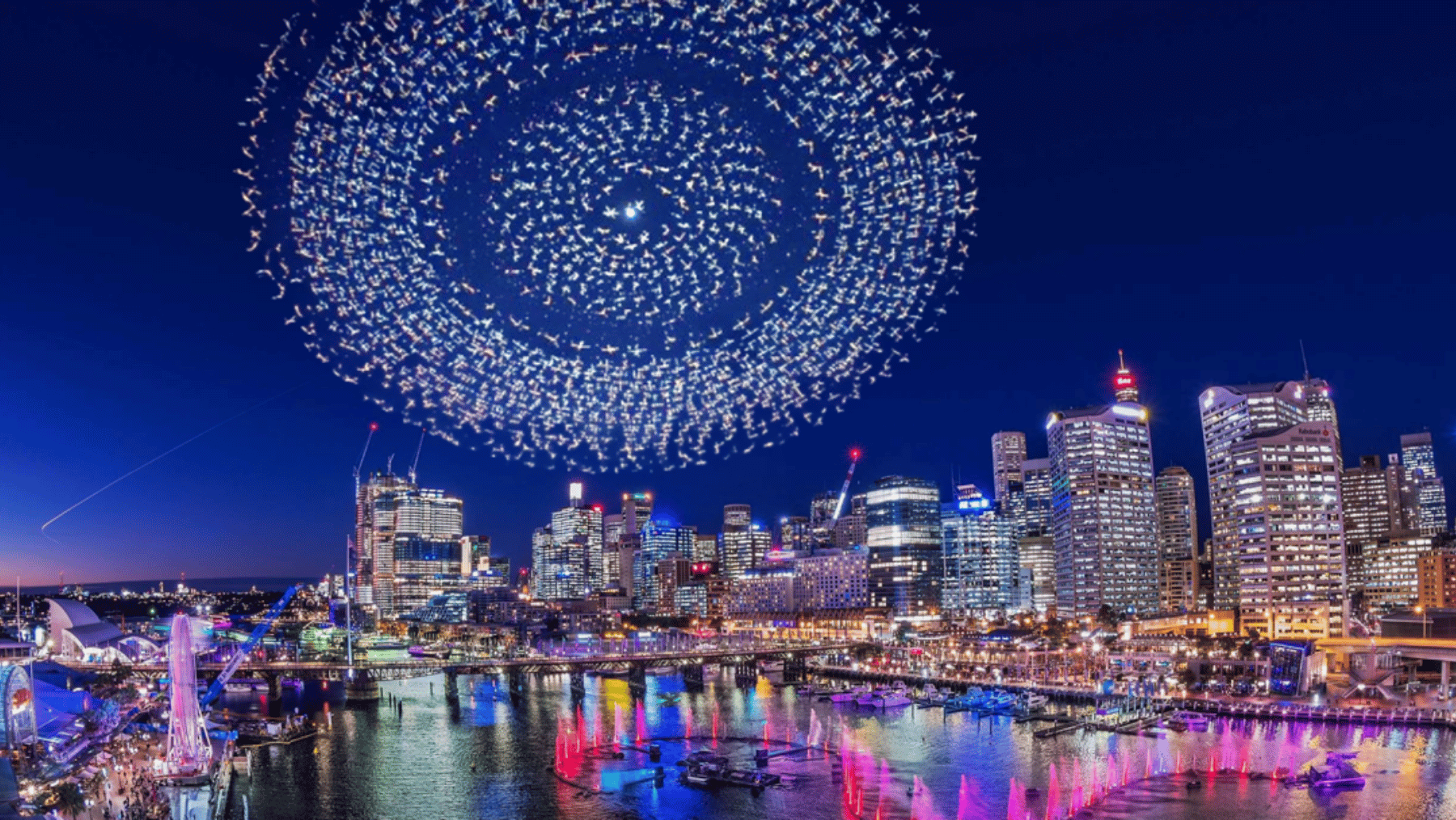 a drone light show of thousands of drones in a circle above sydney
