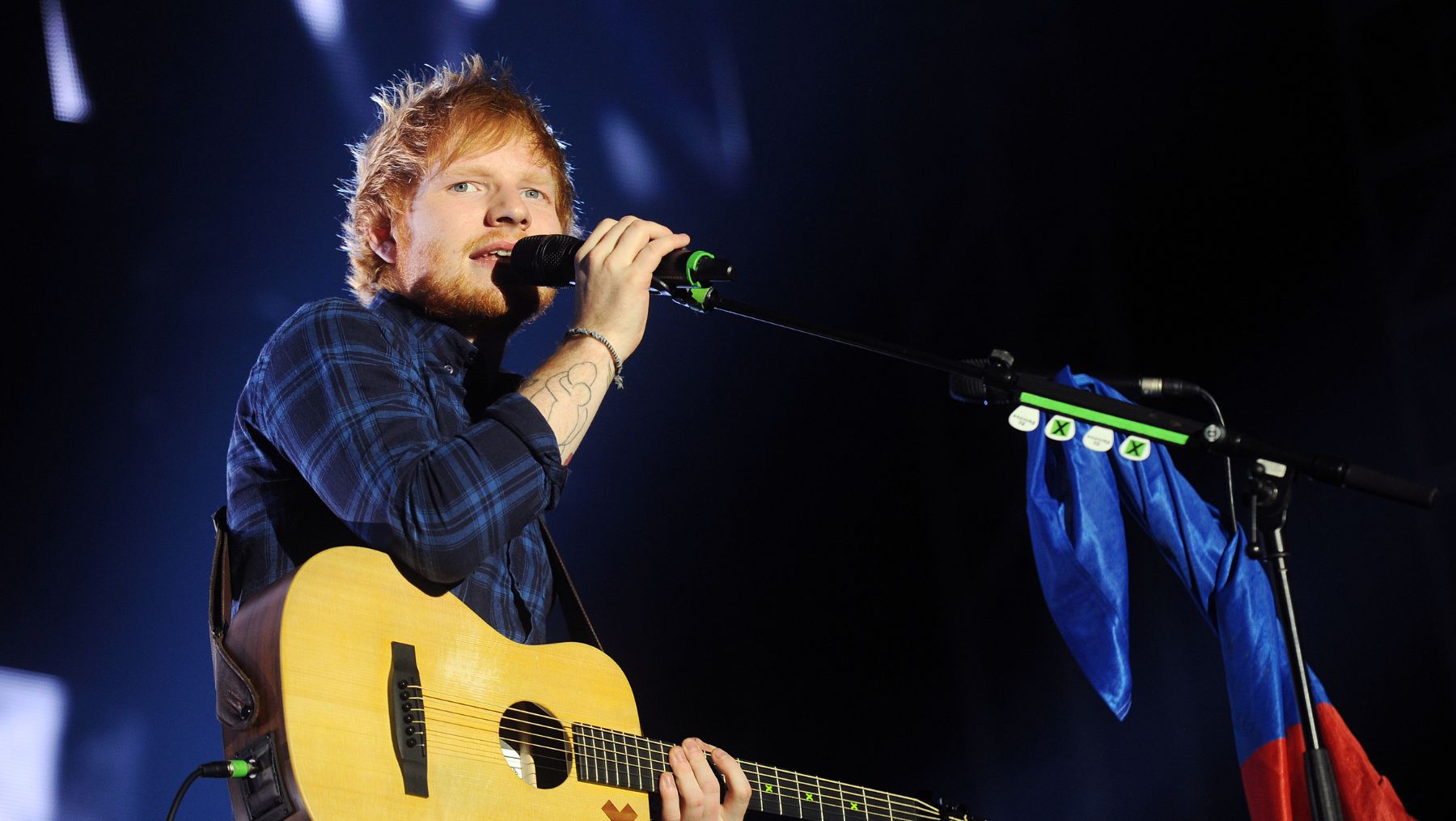 British busker-turned-global superstar Ed Sheeran is pictured on stage.
