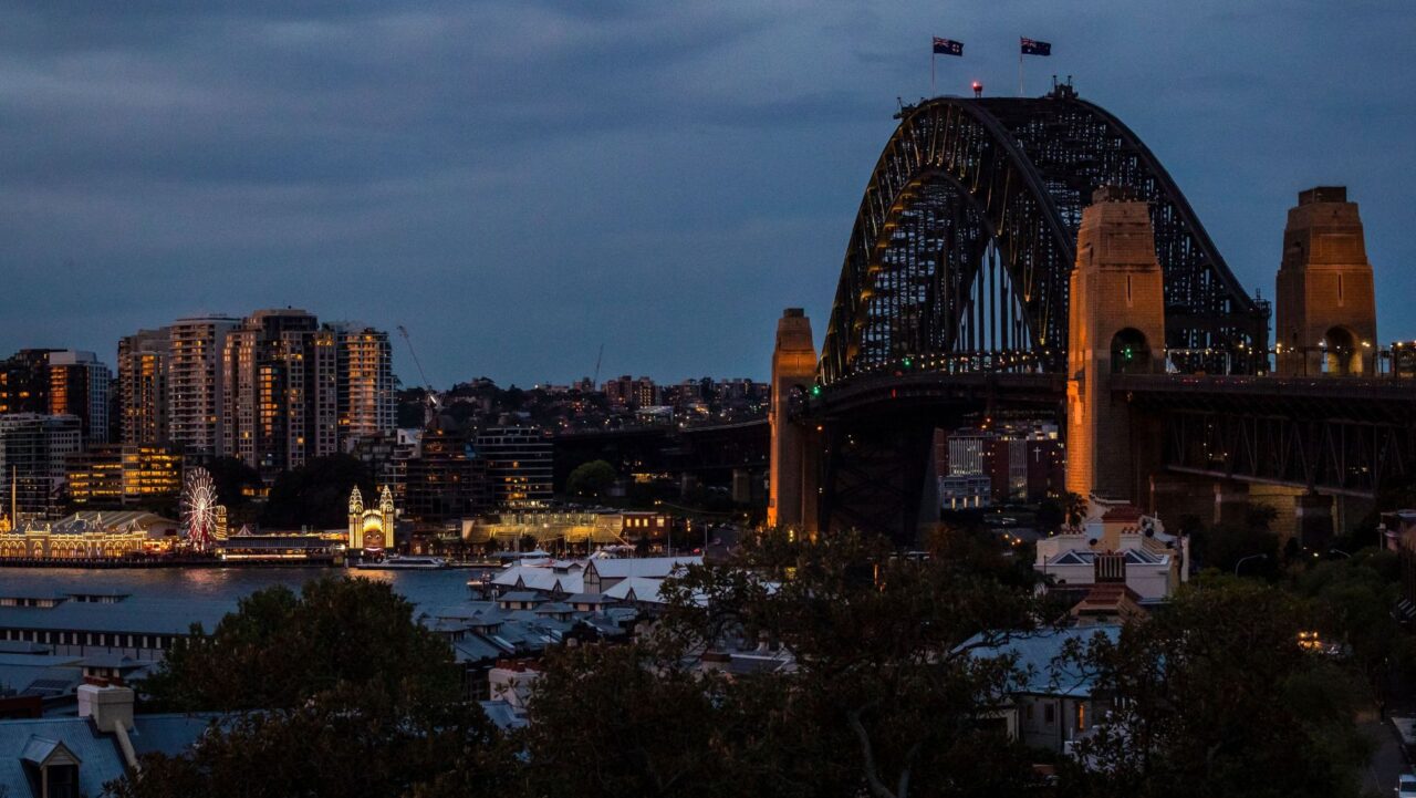 The view of the Sydney Harbour Bridge from Observatory Hill Park, pictured at night.