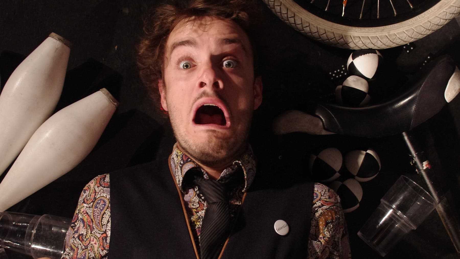 a man lying on the ground with his mouth open