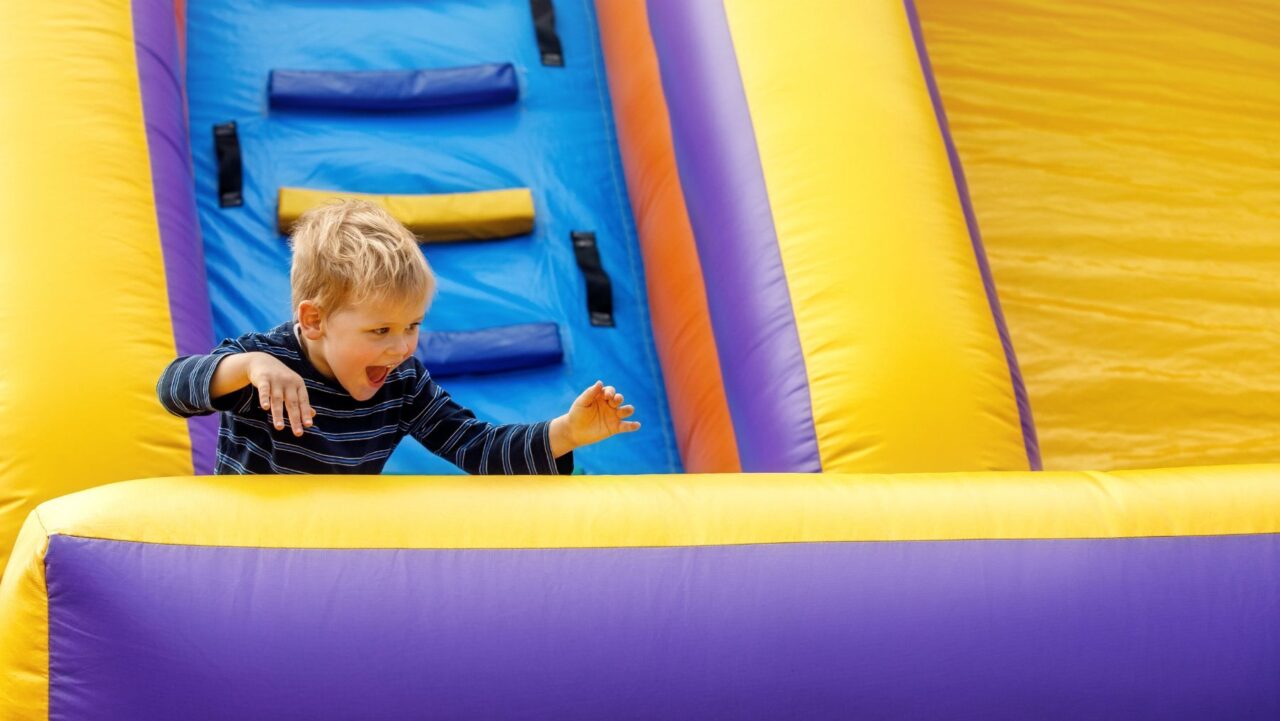 Child on inflatable obstacle course