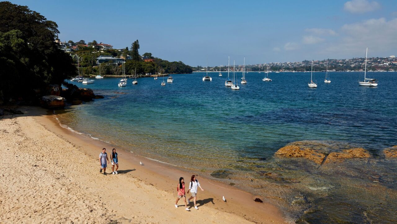 Group walking on Milk Beach on the Hermitage Foreshore Walk, Vaucluse