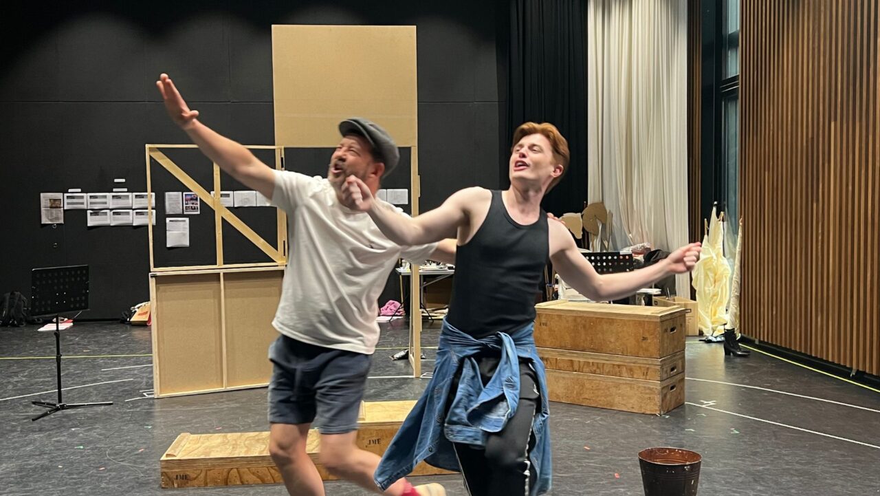 two actors dance