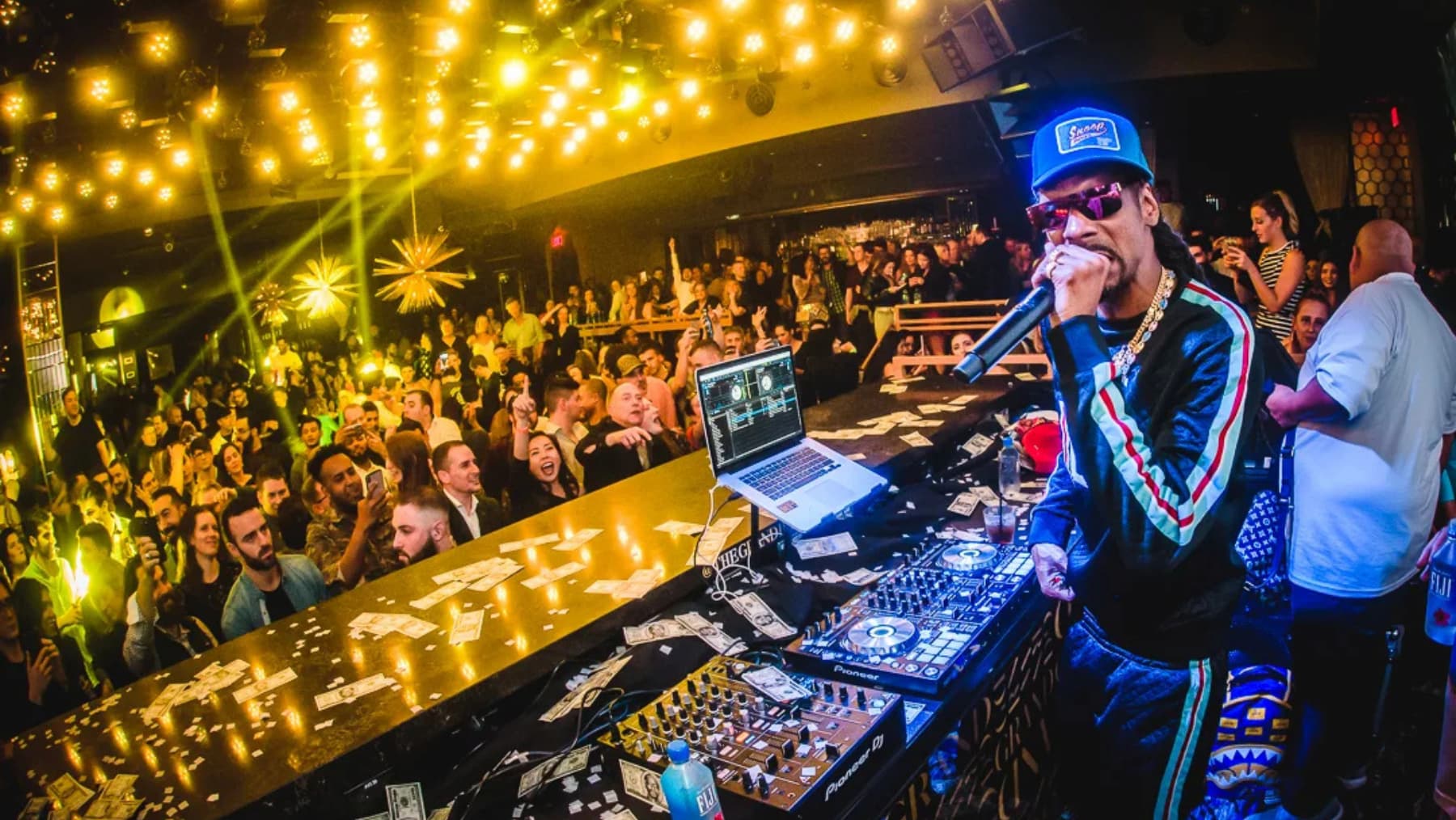 Snoop Dogg DJing at a nightclub.
