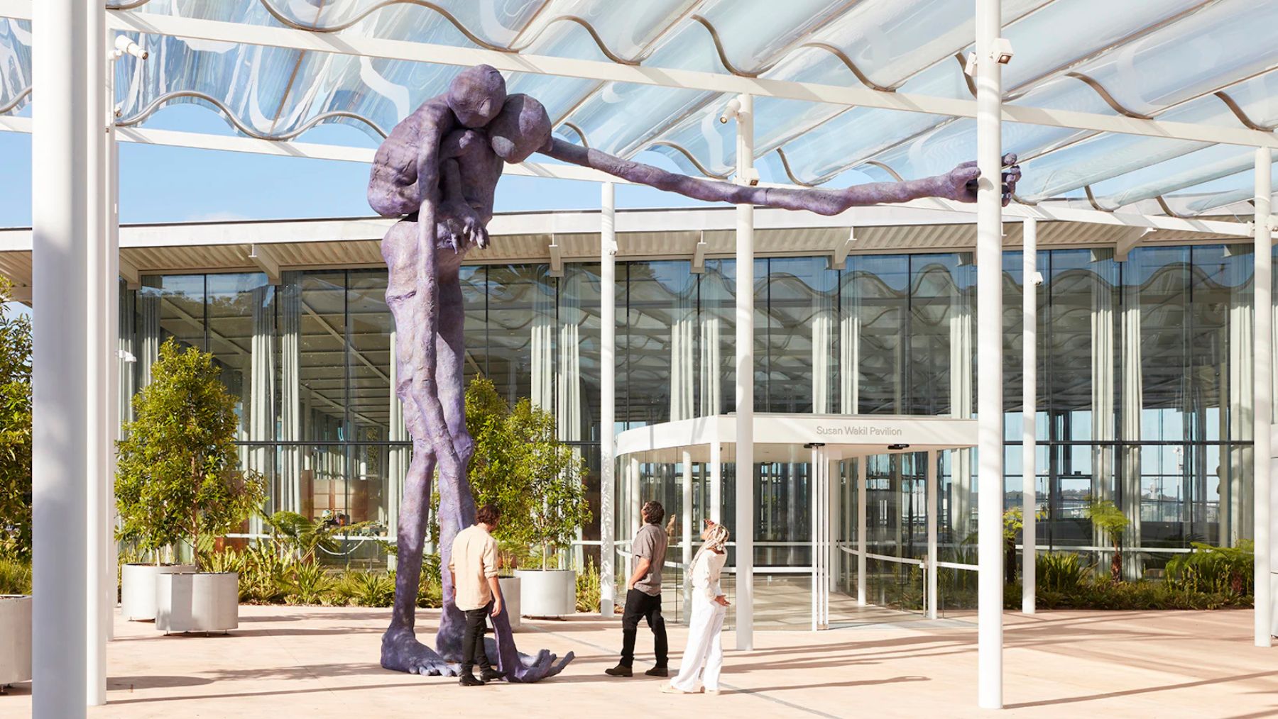 Large purple sculpture with visitors nearby