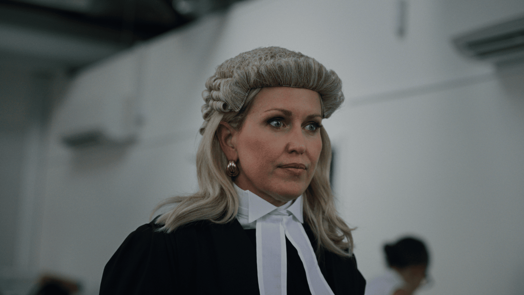 A female barrister in wig and gown from film Silenced