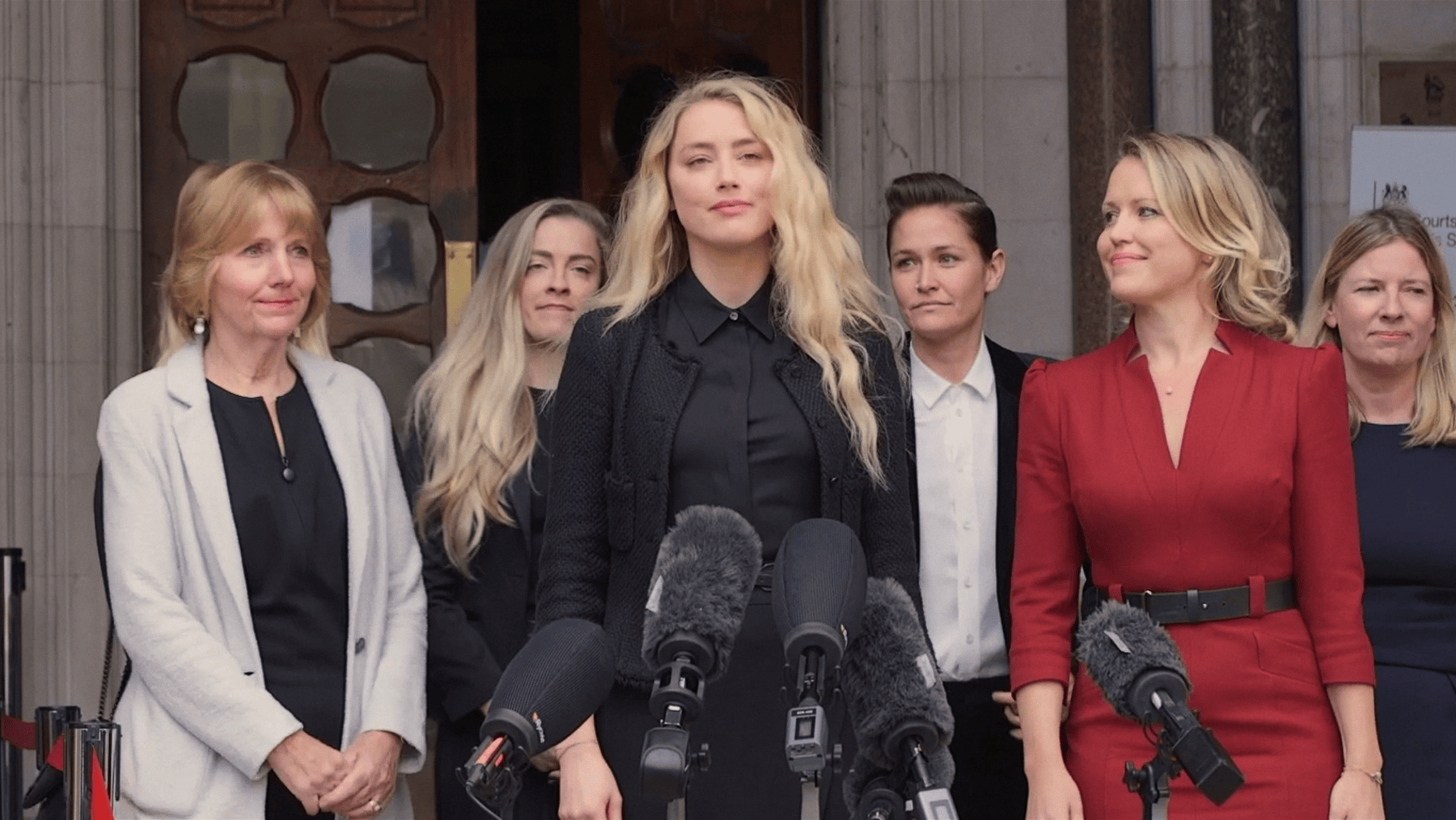 A group of women stand outside court
