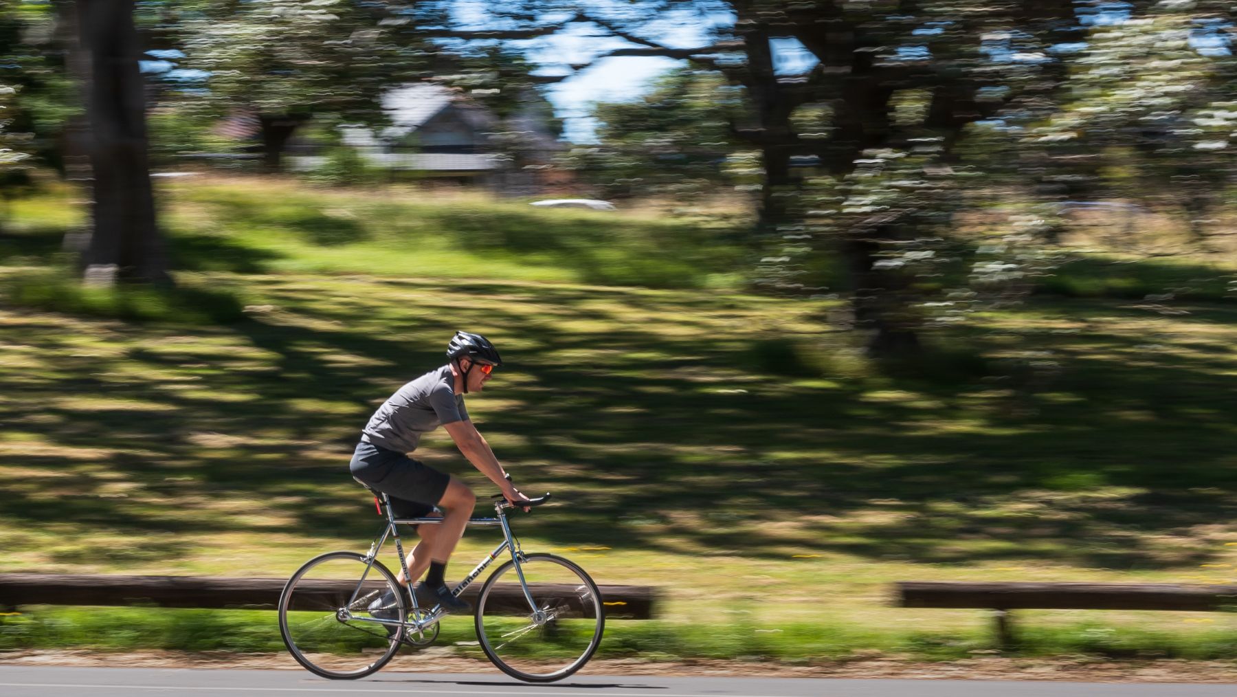 A man cycles around Centennial Park