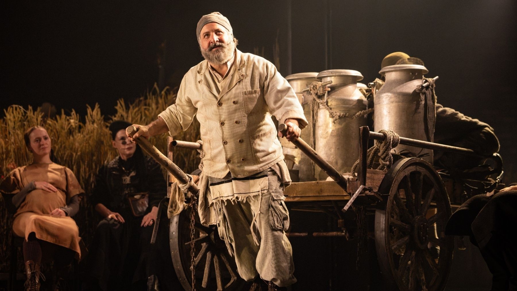 Tevye pulls a cart in theatrical performance of Fiddler on the Roof