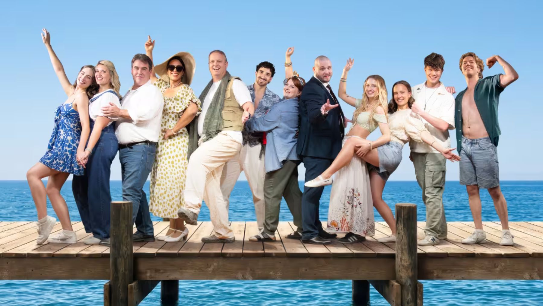 Cast celebrating on a sunny pier.