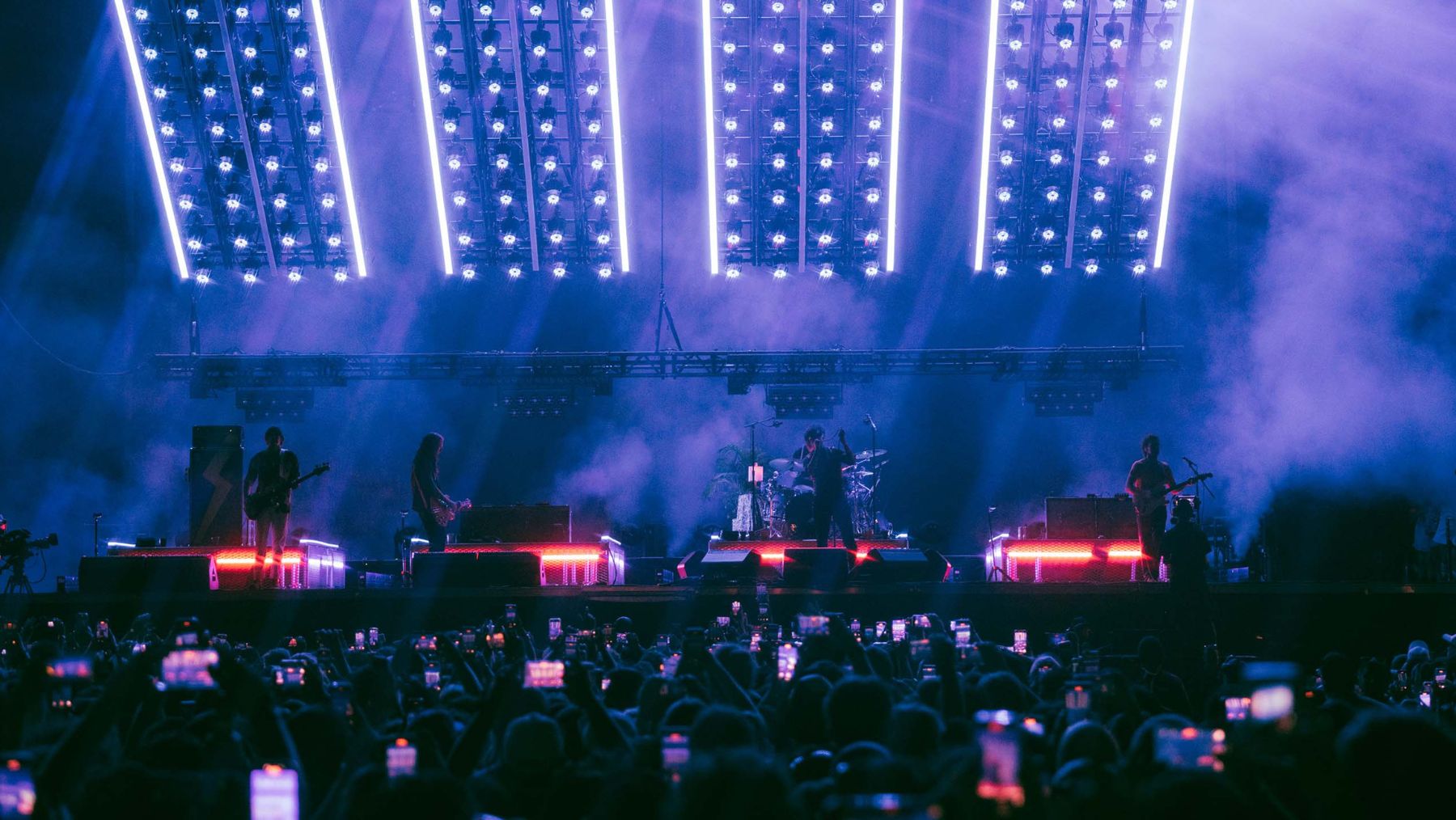 The Strokes Band performing under bright lights